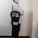 Person carrying aluminum oxygen cylinder