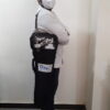 Person carrying aluminum oxygen cylinder