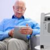 person using Evox oxygen concentrator