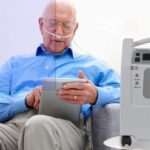 person using Evox oxygen concentrator
